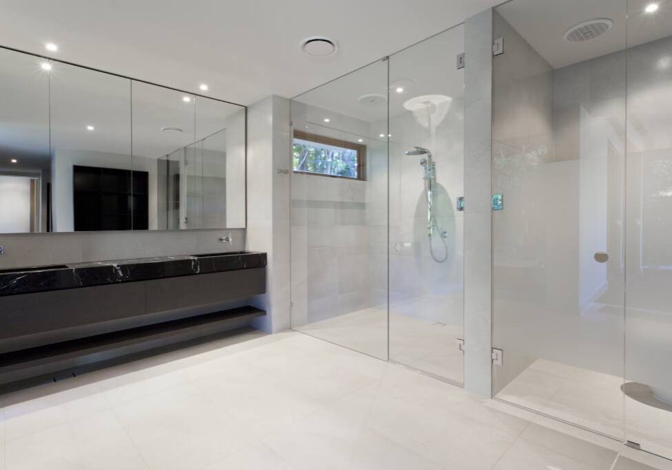 Luxury bathroom with mirrors, sink, shower and toilet